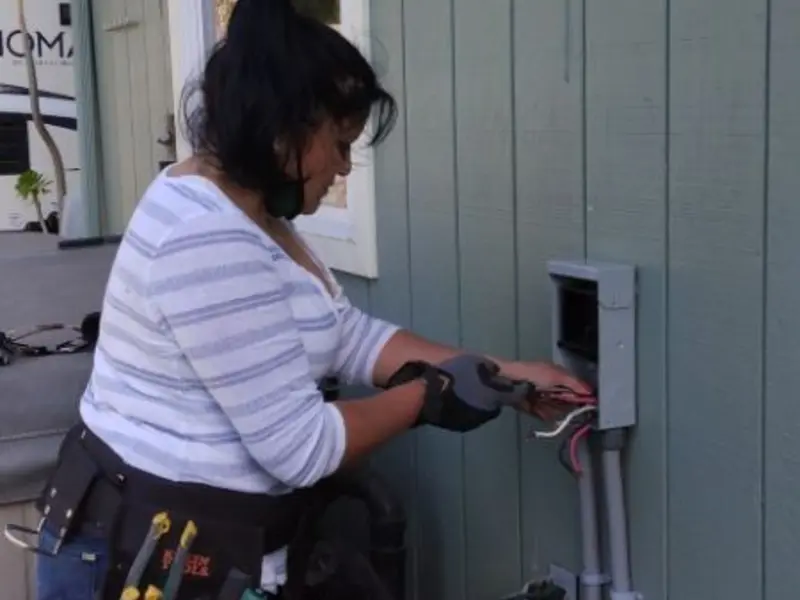 Licensed electrician wiring an exterior subpanel in Belen